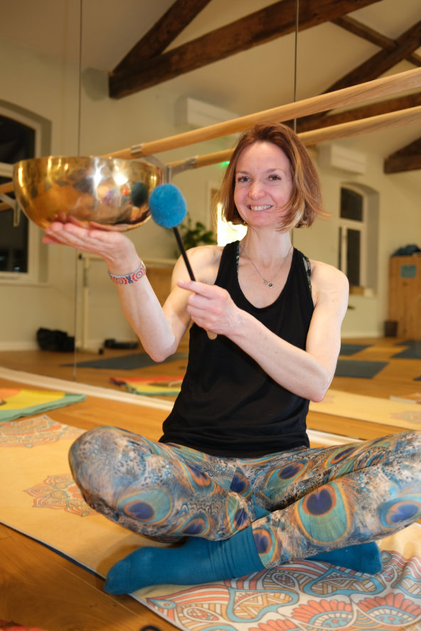 Fiona, the yoga instructor, holding a singing bowl at a Gong Bath event